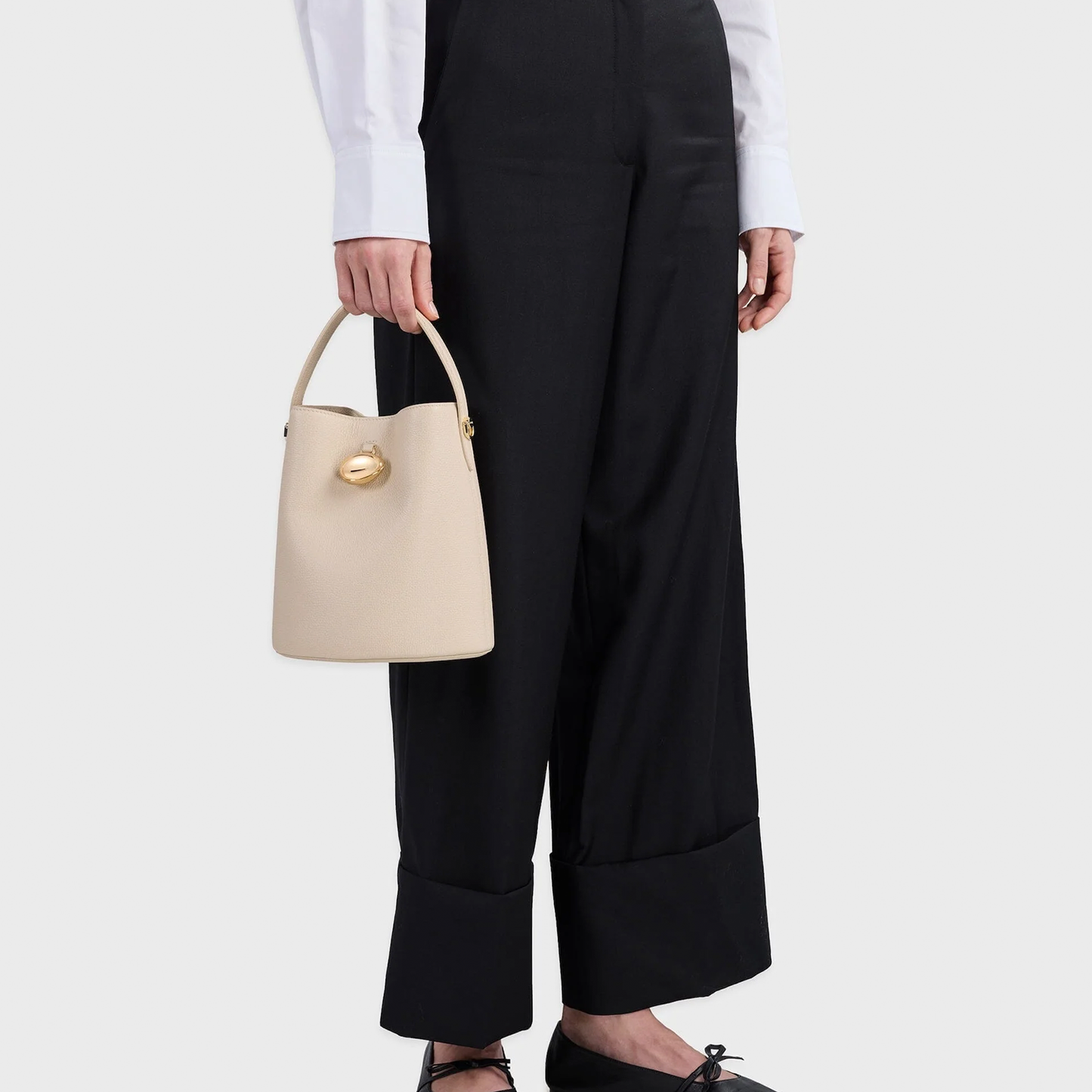 Soft Mushroom Cream Fine Grain Tapered Bucket Hand Bag With Oval Magnetic Clasp, Curved Top Grip And Detachable Slim Shoulder Strap